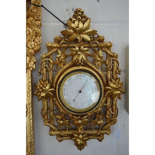 857 - An eight day circular wall clock housed within an ornate carved and gilded frame depicting fruit and... 