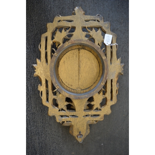 857 - An eight day circular wall clock housed within an ornate carved and gilded frame depicting fruit and... 