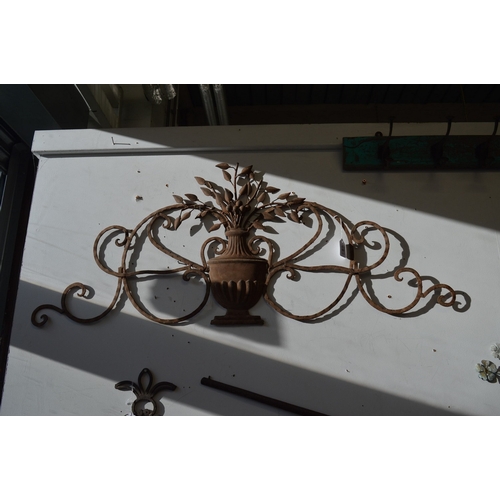 865 - Wrought iron wall sculpture as a vase of flowers.