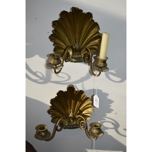 872 - A pair of brass twin branch candle brackets with shell shaped backs.