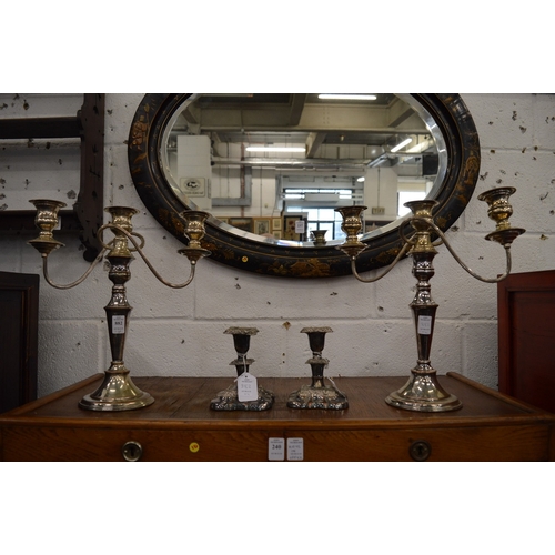 882 - A pair of Sheffield plate twin branch, three light candelabra together with a smaller pair of candle... 