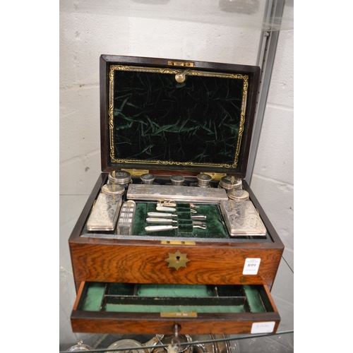 899 - A good Victorian rosewood vanity box containing a fitted interior with cut glass and silver topped j... 