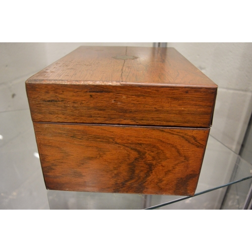 899 - A good Victorian rosewood vanity box containing a fitted interior with cut glass and silver topped j... 