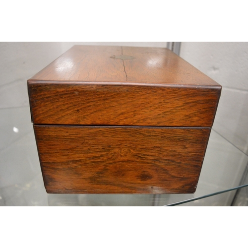 899 - A good Victorian rosewood vanity box containing a fitted interior with cut glass and silver topped j... 