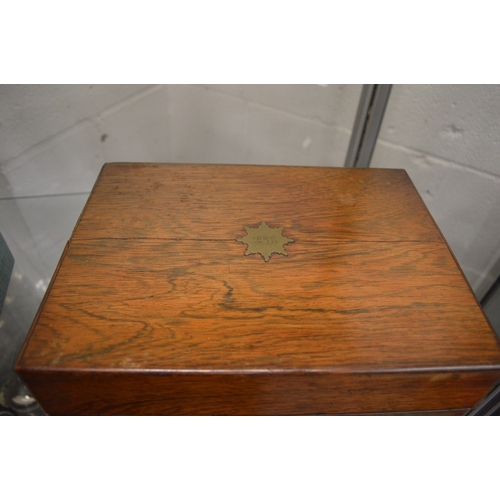 899 - A good Victorian rosewood vanity box containing a fitted interior with cut glass and silver topped j... 