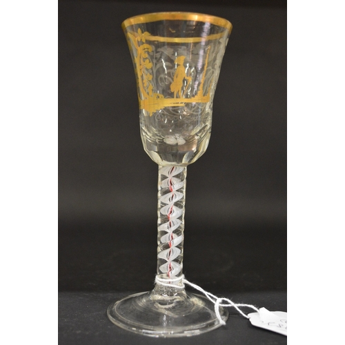 945 - A good Continental engraved and gilded wine glass with opaque and coloured air twist stem.