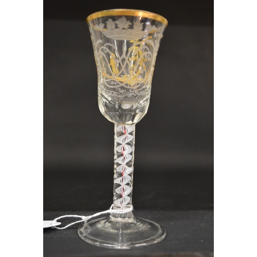 945 - A good Continental engraved and gilded wine glass with opaque and coloured air twist stem.