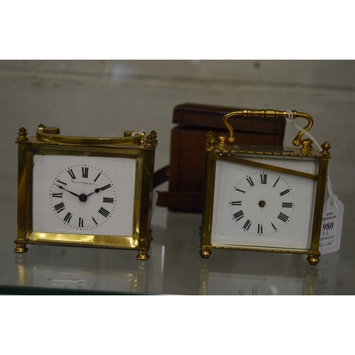 980 - Two brass carriage clocks, both with faults together with a leather travelling case.