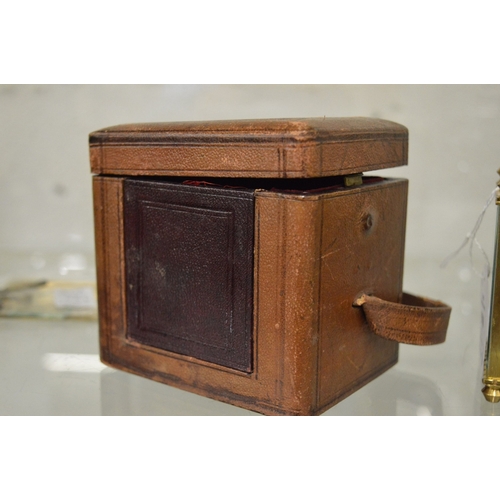 980 - Two brass carriage clocks, both with faults together with a leather travelling case.