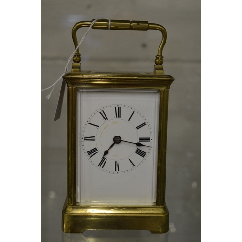 981 - Large brass carriage clock with leather travelling case and key.