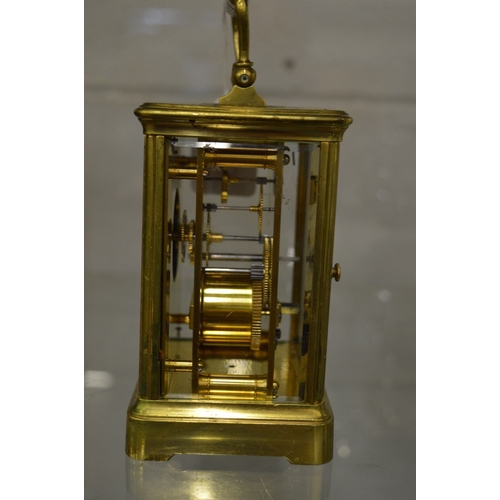 981 - Large brass carriage clock with leather travelling case and key.