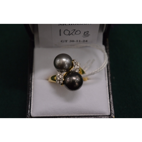 1020B - An 18ct  gold, diamond and pearl crossover ring.