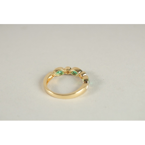 1000 - AN 18CT YELLOW GOLD, EMERALD AND DIAMOND HALF HOOP ETERNITY RING.