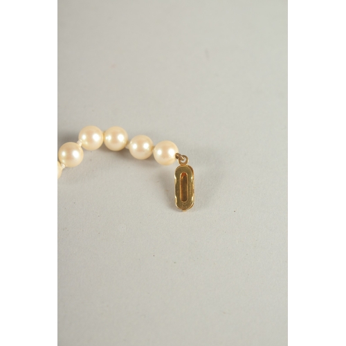 1007 - A STRING OF PEARLS, with 9ct gold clasp. 41cms long.