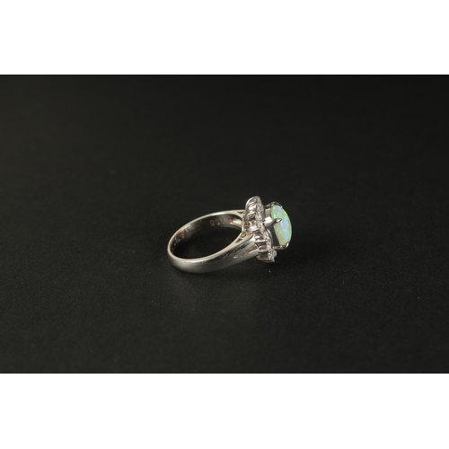 1011 - A PLATINUM RING set with a cabochon oval opal and a halo of RBC diamonds in a small ring size. Opal ... 