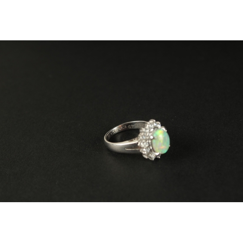 1011 - A PLATINUM RING set with a cabochon oval opal and a halo of RBC diamonds in a small ring size. Opal ... 