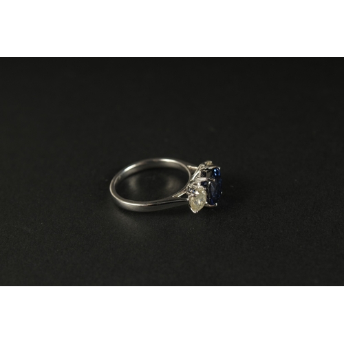 1016 - A CERTIFICATED 18CT WHITE GOLD SYNTHETIC SAPPHIRE AND DIAMOND TRILOGY RING. Oval sapphire 2.87ct. RB... 