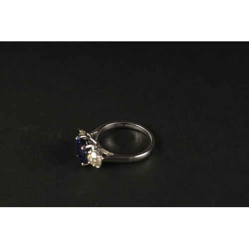 1016 - A CERTIFICATED 18CT WHITE GOLD SYNTHETIC SAPPHIRE AND DIAMOND TRILOGY RING. Oval sapphire 2.87ct. RB... 