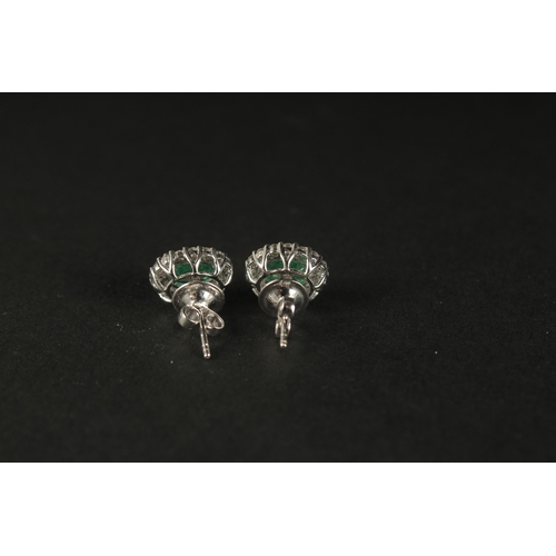 1021 - A PAIR OF OVAL EMERALD AND RBC DIAMOND CLUSTER STUDS, boxed. Emeralds 2.08ct. Diamonds 0.73ct.