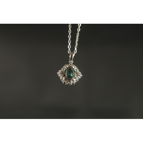 1024 - A CERTIFICATED 18CT WHITE GOLD PENDANT set with oval-cut emerald and a halo of RBC and tapered bague... 