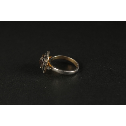 1026 - A SILVER GILT DRESS RING set with a central fancy brown rose-cut cushion-shaped diamond and two halo... 