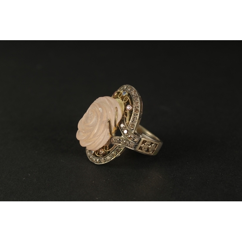 1028 - A LARGE AND IMPRESSIVE SILVER GILT RING set with a large carved rose quartz and coloured diamonds, b... 