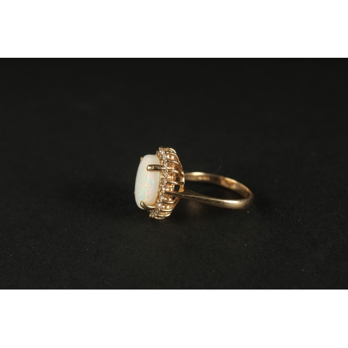 1032 - A TRADITIONAL STYLE 14CT YELLOW GOLD CLUSTER RING set with an oval cabochon white opal, surrounded b... 