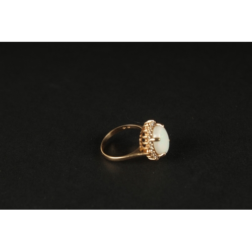 1032 - A TRADITIONAL STYLE 14CT YELLOW GOLD CLUSTER RING set with an oval cabochon white opal, surrounded b... 