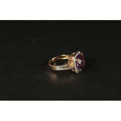 1036 - AN 18CT YELLOW GOLD RING set with a large checkerboard cushion-cut amethyst surrounded by RBC diamon... 