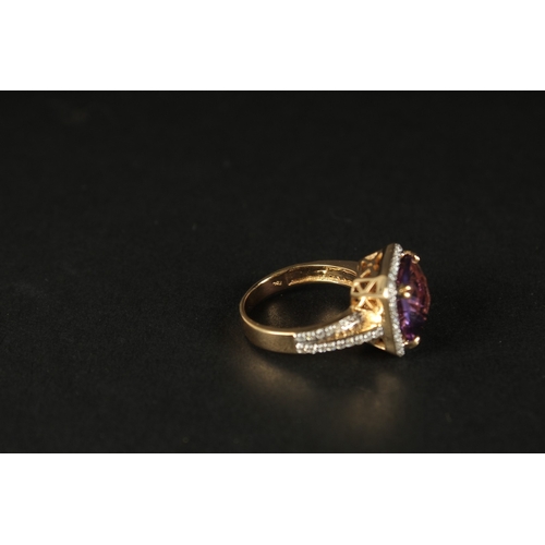 1036 - AN 18CT YELLOW GOLD RING set with a large checkerboard cushion-cut amethyst surrounded by RBC diamon... 