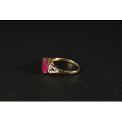 1039 - A 9CT YELLOW GOLD OVAL RUBY RING with diamonds set to the shoulders, boxed.