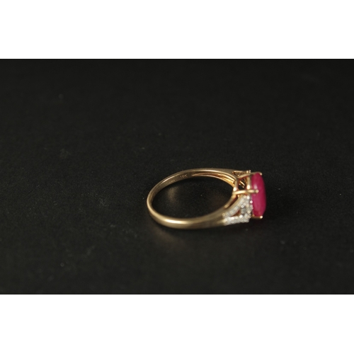 1039 - A 9CT YELLOW GOLD OVAL RUBY RING with diamonds set to the shoulders, boxed.