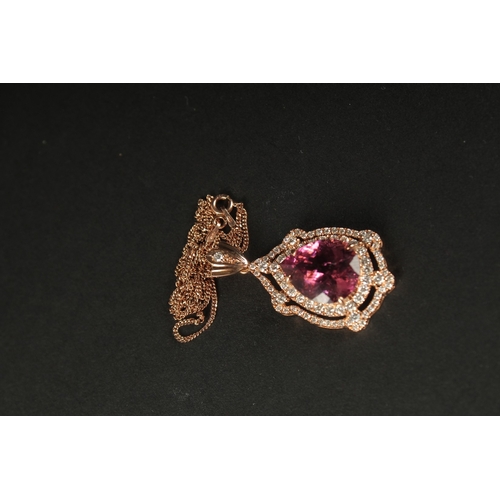 1041 - AN 18CT ROSE GOLD PENDANT set with large pear-shaped pink tourmaline surrounded by RBC diamonds with... 