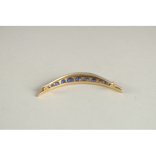 1055 - A GOLD, DIAMOND AND SAPPHIRE CRESCENT BROOCH.