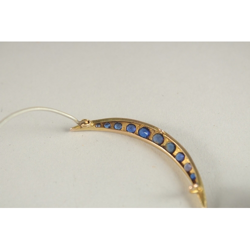 1055 - A GOLD, DIAMOND AND SAPPHIRE CRESCENT BROOCH.