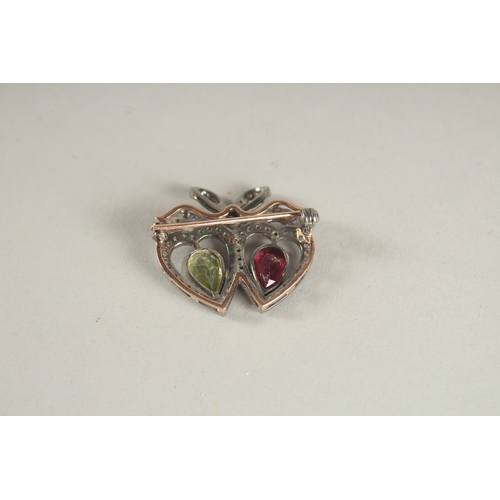 1057 - A DIAMOND, PERIDOT AND RUBY HEART BROOCH.