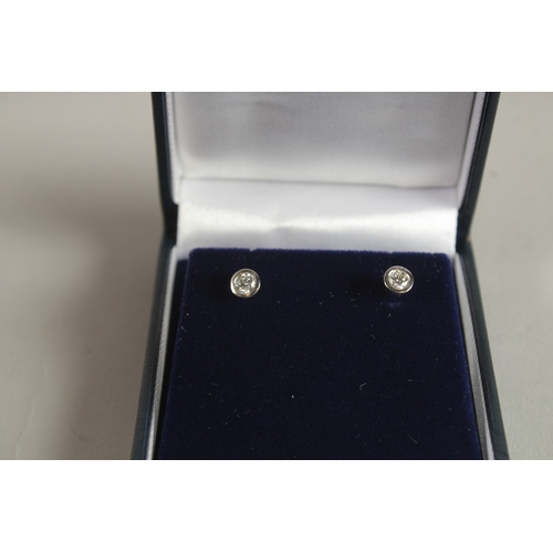 1069 - A PAIR OF 18CT WHITE GOLD AND DIAMOND EAR STUDS. 0.45ct.