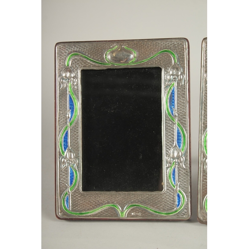 1151 - A PAIR OF SILVER AND ENAMEL PHOTOGRAPH FRAMES. 7.5ins x 5.5ins.