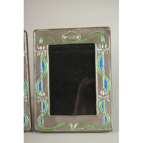 1151 - A PAIR OF SILVER AND ENAMEL PHOTOGRAPH FRAMES. 7.5ins x 5.5ins.