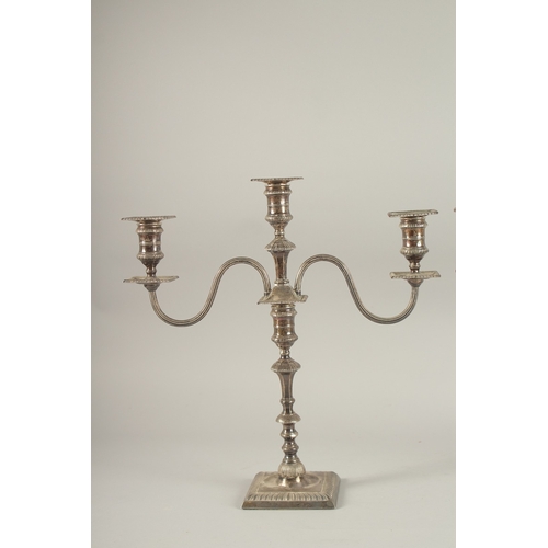 1152 - A GOOD PAIR OF SILVER TWO BRANCH CANDLESTICKS on square loaded bases. 14ins high. Sheffield 1922.... 