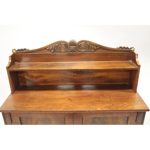 518 - A LATE REGENCY MAHOGANY CHIFFONIER with shaped back, single shelf over a pair of double doors, on tu... 