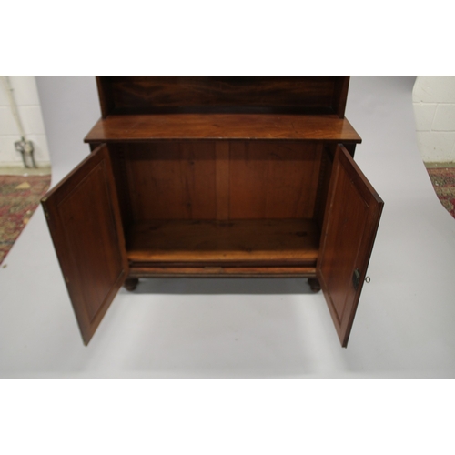 518 - A LATE REGENCY MAHOGANY CHIFFONIER with shaped back, single shelf over a pair of double doors, on tu... 