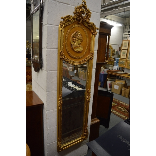 524 - A PAIR OF FRENCH STYLE GILDED NARROW WALL MIRRORS.