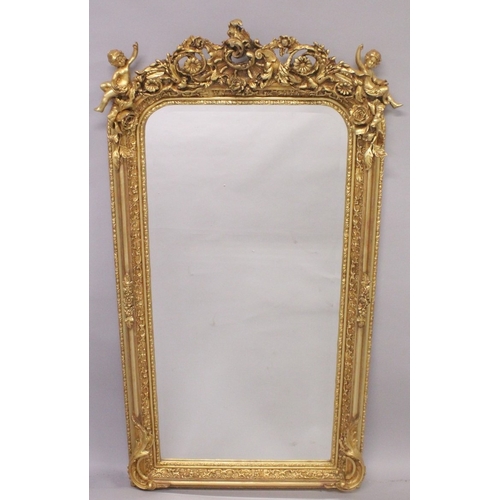 539 - A GOOD LOUIS XVITH STYLE GILTWOOD UPRIGHT MIRROR, carved with cupids and scrolls. 63ins high x 31ins... 