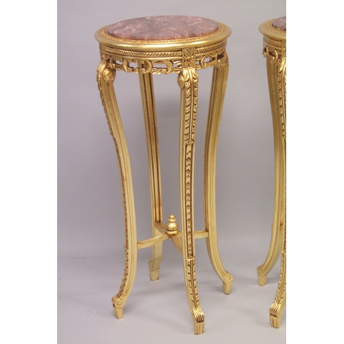 553 - A TALL PAIR OF GILTWOOD CIRCULAR MARBLE TOP STANDS on four curving legs. 44ins high x 18ins diameter... 