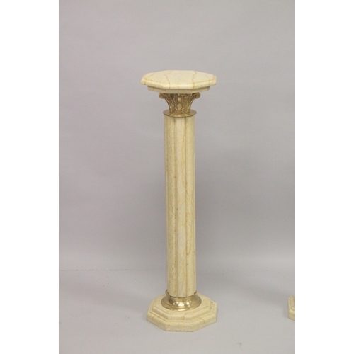 558 - A GOOD PAIR OF BEIGE MARBLE TOP COLUMNS. 39ins high.