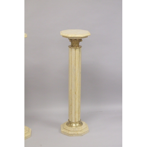 558 - A GOOD PAIR OF BEIGE MARBLE TOP COLUMNS. 39ins high.