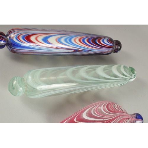 572 - THREE PIECES OF NAILSEA GLASSWARE, to include two rolling pins and a flask. Rolling Pins: 35cms and ... 