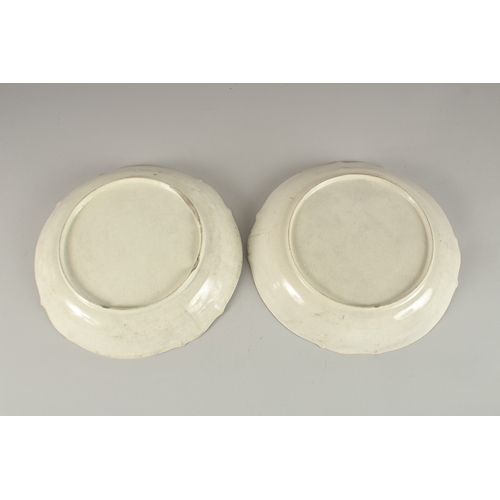 593 - A PAIR OF FRENCH PORCELAIN DISHES, decorated to the centre with a portrait. 29cms diameter.