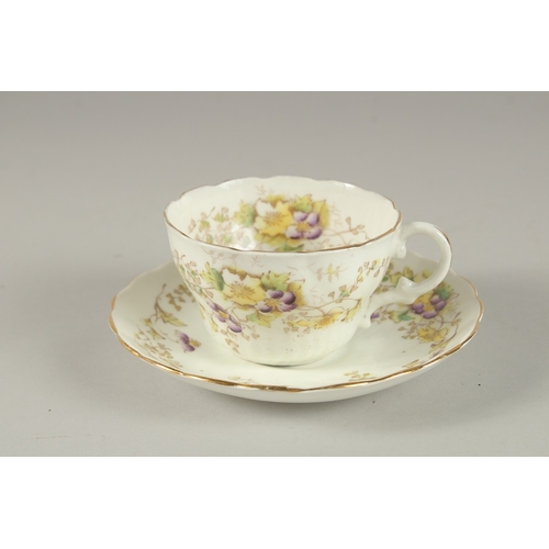 596 - AN AMUSING FLORAL CUP AND SAUCER, painted to the bottom of the cup 